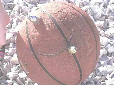 Why won't anyone play basketball with me? The basekatball was used as a backstop for the 12 grams after they sliced through the aerosol cans. The only reason they stopped outside the ball and didnt go completely through is because of the contact they made with a plastic chlorine bucket (nice thick walls on those babies).