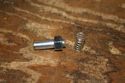 Cut the head off of your 3/8&amp;quot; bolt. Thread a nut on and snug it down. Cut the threaded portion 1/8&amp;quot; out from the nut. Chuck it in the drill press and file the threads until the spring fits slightly loose. Remove from drill press. Place an 012 o-ring and 2 flat washers on the long end. Mark and cut here. Clean up the cut with the file and bevel the edge. File two flat spots on this end. (look at the pictorial if in doubt) Turn off the nut, apply Loctite or epoxy to seal the threads. Spin the nut back on, snug it, and clean off any excess Loctite or epoxy.