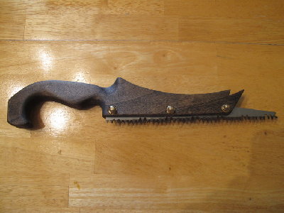 Steel Saws-All blade and poplar handle. Blade is 8&amp;quot;.