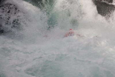 7 guys in the raft going down the creek.