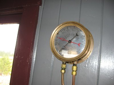 In the middle of the caboose in the capula is this gauge. The pipes lead down to a valve..