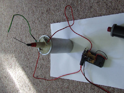 This is how it should be connected to an ignition coil. The positive side of the capacitor to the positve tab on the coil and so on. The High Voltage is between the Negative Tab and the main plug bit coming out the middle. Use wire with a fairly thick insulation on the high voltage side. Don't use a sparkplug lead as these have a high resistance and make the spark smaller.