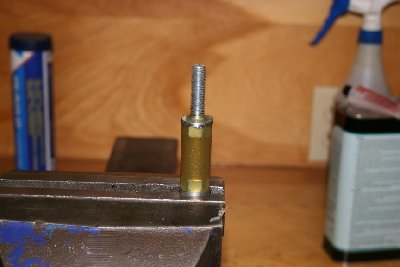 When the resin has fully cured, you can tap the piston out of the mold. Clean the grease from the piston and mold. Chuck the long end into the drill press and wet sand until the piston fits in the tube with a very small amount of clearance.