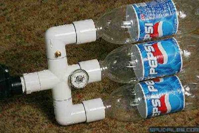 The pressure chamber consists of three 1-liter wide-mouth soft drink bottles connected through a cross joint and two 90 degree elbows, all of 1&amp;quot; PVC. The pressure gauge and fill valve were installed in 1/4&amp;quot; NPT tapped holes drilled in the fittings.<br /><br />The soda bottles were chosen primarily for their light weight, but the choice is somewhat controversial. Although there are sources on the Internet that indicate the industry pressure-tests these containers up to 150psi, or that have destructively tested the bottles to 170psi, they are designed for holding pressurized liquids, and it is not guaranteed that they can hold pressurized air safely. The reader is cautioned that all responsibility for safety rests with him, and normal precautions (eye protection, protective clothing, etc.) should be used.<br /><br />I have personally tested the chamber above up to 90psi without any visible signs of stress, but I don't intend to use it above 60psi in the field. The tallest tree we shot this year (over 100ft) only required the use of 45psi pressure. Because of the double-thickness on all of the PVC fittings on the pressure side of the valve, I have few concerns about that part of the system.